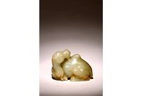 A CHINESE CELADON JADE CARVED FIGURE OF CAMEL