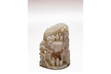 A CHINESE CELADON JADE CARVED 'FIGURES' BOULDER