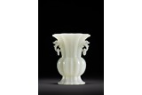 A CHINESE WHITE JADE CARVED FLUTED VASE