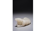 A CHINESE WHITE JADE CARVING OF RECUMBENT DOG