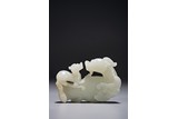 A CHINESE WHITE JADE CARVING OF DRAGONS