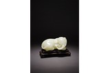 A CHINESE WHITE JADE CARVED RECUMBENT ELEPHANT 