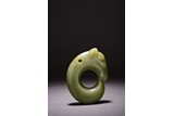 AN ARCHAIC CHINESE CELADON JADE CARVED 'PIG DRAGON' 