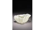 A CHINESE WHITE JADE 'LOTUS LEAF' WASHER