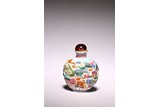 A CHINESE MOULDED FAMILLE ROSE 'BUDDHIST LIONS' SNUFF BOTTLE