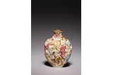 A CHINESE FAMILLE ROSE 'EIGHTEEN ARHATS' SNUFF BOTTLE