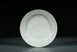 A WHITE GLAZE MOULDED 'DRAGON' DISH