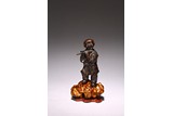 A CHINESE BRONZE 'BOY PLAYING FLUTE'