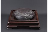 A VERY LARGE DUAN INKSTONE WITH HARDWOOD STAND