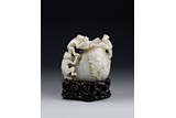 A WHITE JADE CARVED 'MONKEYS AND BAG' CARVING