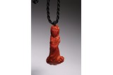 AN AKA RED CORAL CARVED 'GUANYIN' PENDANT