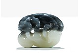 A WHITE AND BLACK JADE CARVING OF TWO CATS