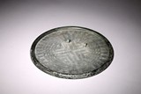 A LARGE ARCHAIC CHINESE BRONZE MIRROR