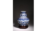 A LARGE BLUE AND WHITE FLORAL SCROLL BOTTLE VASE