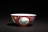 A FAMILLE ROSE RED GROUND 'LANDSCAPE' BOWL