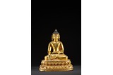 A GILT BRONZE FIGURE OF SHAKYAMUNI BUDDHA