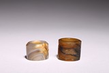 A SET OF TWO CHINESE AGATE ARCHER'S RINGS