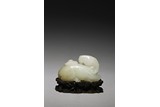 A CHINESE WHITE JADE RECUMBENT RAM CARVING