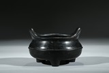 A BRONZE TRIPOD CENSER