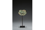 AN ARCHAIC BRONZE MYTHICAL MASK