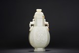 A CHINESE WHITE JADE 'TAOTIE' VASE WITH COVER