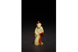 A CELADON JADE CARVED FIGURE