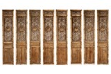 A SET OF EIGHT CHINESE RELIEF CARVED WOOD DOOR PANELS 