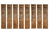 A SET OF EIGHT CHINESE RELIEF CARVED WOOD DOOR PANELS 