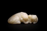 A WHITE JADE CARVING OF MYTHICAL BEASTS GROUP