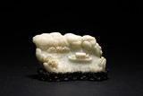 A CHINESE WHITE JADE BOULDER WITH STAND