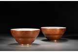 A PAIR OF GILT DECORATED RED GROUND BOWLS