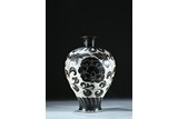 A BRONZE WHITE GROUND BLACK FOLIATE SCROLL DECORATED VASE