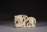 A CHINESE CELADON FIGURE OF DRAGON
