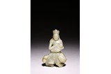 A CHINESE CELADON JADE CARVED FIGURE