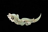 AN ARCHAIC CELADON JADE 'DRAGON' PENDANT