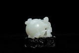 A CHINESE WHITE JADE 'BOY AND PEACH' CARVING