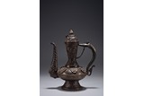 A PARCEL GILT REPOUSSE BRONZE EWER WITH COVER