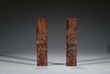 A PAIR OF ROSEWOOD CARVED 'RED CLIFF' WRIST RESTS