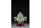 A CELADON JADE CARVED 'TAOTIE' MYTHICAL BEAST TRIPOD CENSER