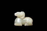 A CHINESE CELADON JADE CARVED RAM