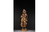 A PARCEL GILT BRONZE FIGURE OF STANDING BODHISATTVA