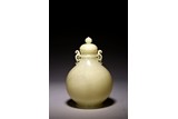 A WHITE JADE 'BIRD AND FLOWERS' GLOBULAR VASE
