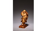 A CHINESE WOOD CARVED LUOHAN FIGURE