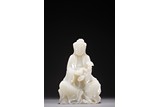 A WHITE JADE CARVED FIGURE OF GUANYIN WITH RUYI