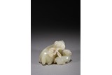 A CHINESE WHITE JADE RAM FIGURAL CROUP