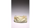 A CELADON JADE 'CHILONG AND BEAST MASK' PAPERWEIGHT
