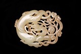 A CHINESE CELADON JADE OPENWORK 'DRAGON' PENDANT