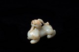 A CHINESE WHITE AND RUSSET JADE CARVED BIXIE