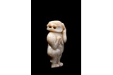 A JADE CARVING OF STANDING MYTHICAL BEAST