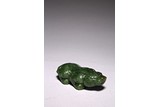 A SPINACH GREEN CARVED JADE MYTHICAL BEAST